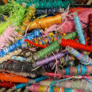 Bobbins for weaving wound with a variety of novelty yarns