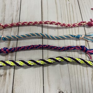 Four colorful kumihimo braids made from satin rattail cord