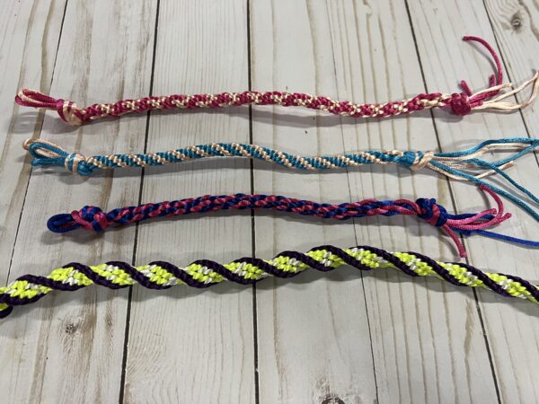 Four colorful kumihimo braids made from satin rattail cord