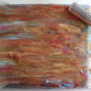 blending board full of fibers in shades of oranges and yellows