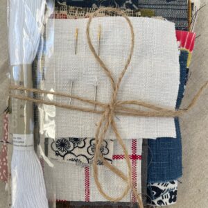 bundle of fabric and sewing needles