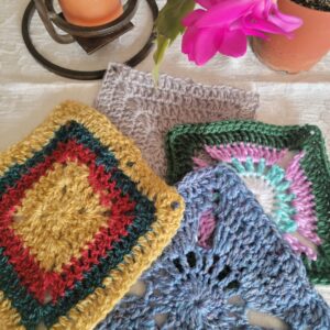 several colorful crocheted granny squares