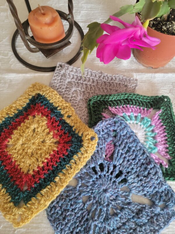 several colorful crocheted granny squares