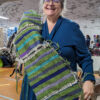 Student holding length of freestyle weaving