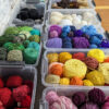 Boxes full of colorful yarn cakes