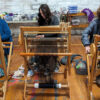 Students weaving on floor looms